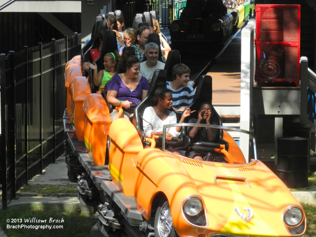 Orange train departing the station.