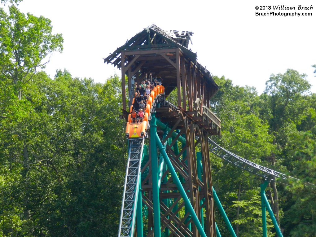 Orange train falling out of the broken bridge.