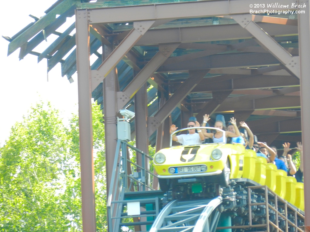 The yellow train just before it starts falling out of the broken bridge.