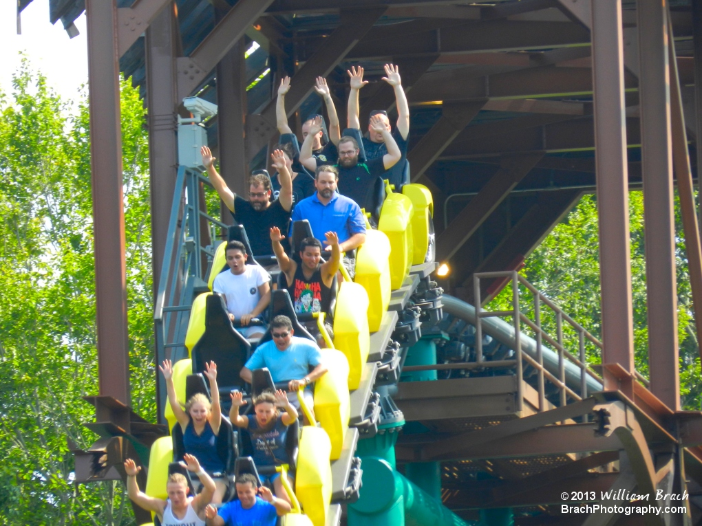 Yellow train falling out of the broken bridge.