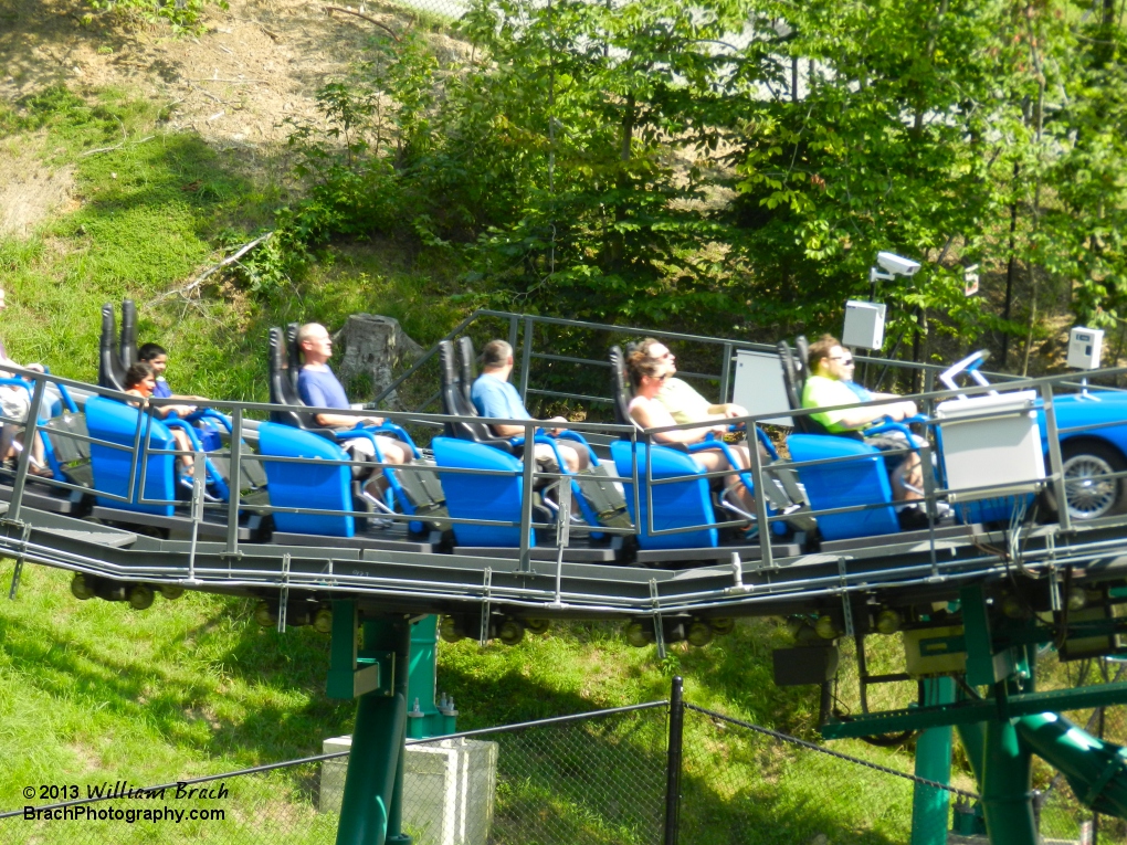 Blue train getting launched into the Black Forest.