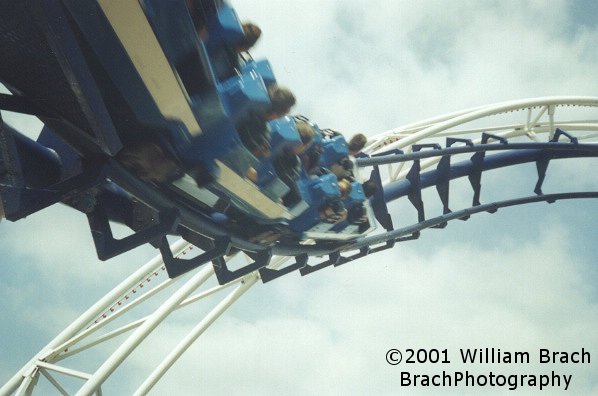 Blue train running the corkscrews.  Corkscrew was a groundbreaking coaster for Arrow.  When it was built, it was the first Arrow looper that went over a walkway, allowing peeps to watch the train up close.