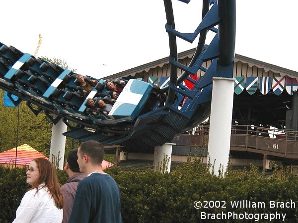 Blue train rushing towards the double corkscrews.