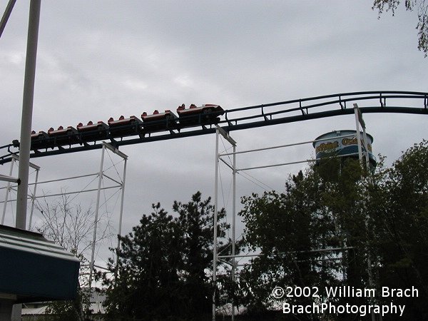 Red train has exited the vertical loop and is no on the straight bit of track (WHY is that there?!  Was it intended to be used as a trim brake-run?) bnefore entering the corkscrews.