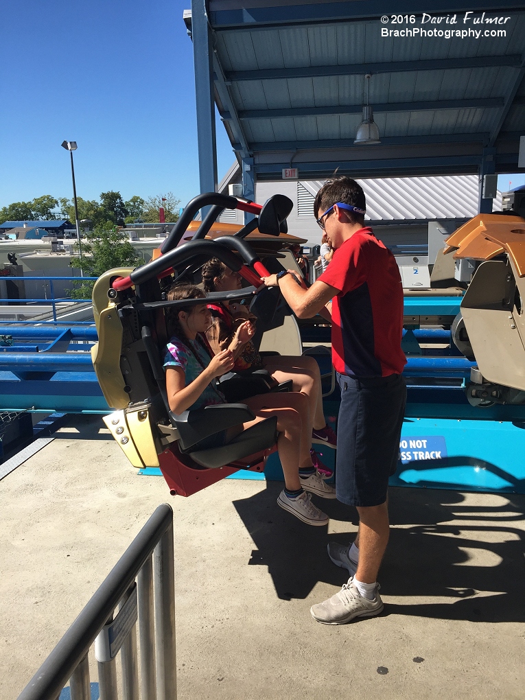 GateKeeper Crew Member helps secure a rider into the restraints.