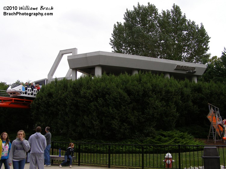 Magnum XL-200's station.  Mostly covered by bushes.  The blue train is seen departing for its journey.