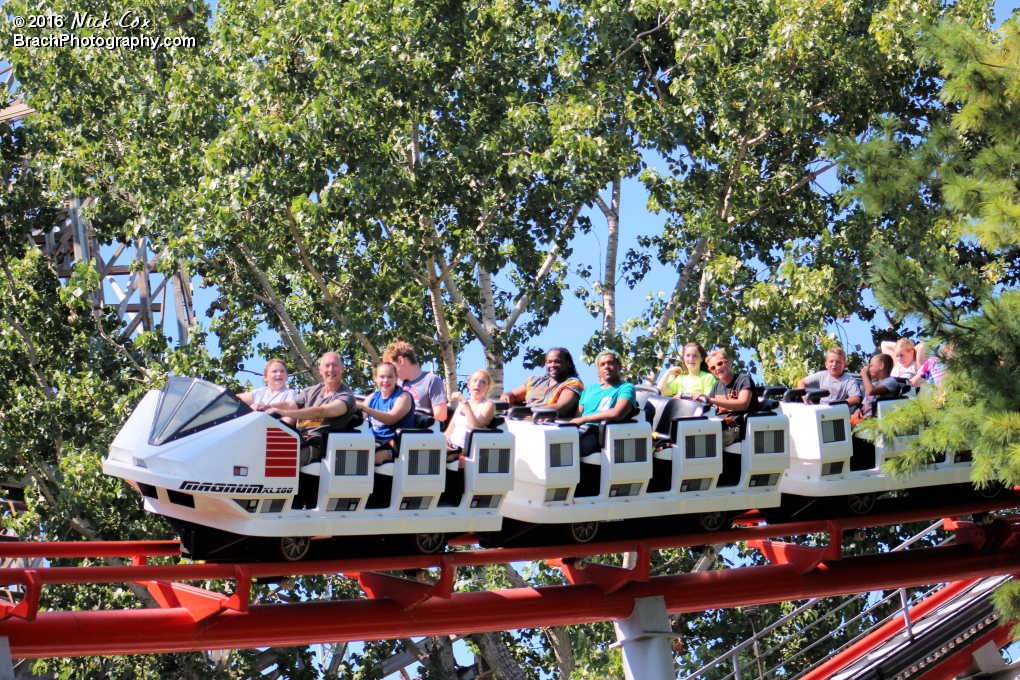 The train peeking out from the trees.