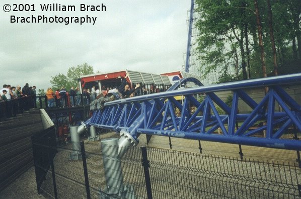 Millennium Force train rushing past the queue line.