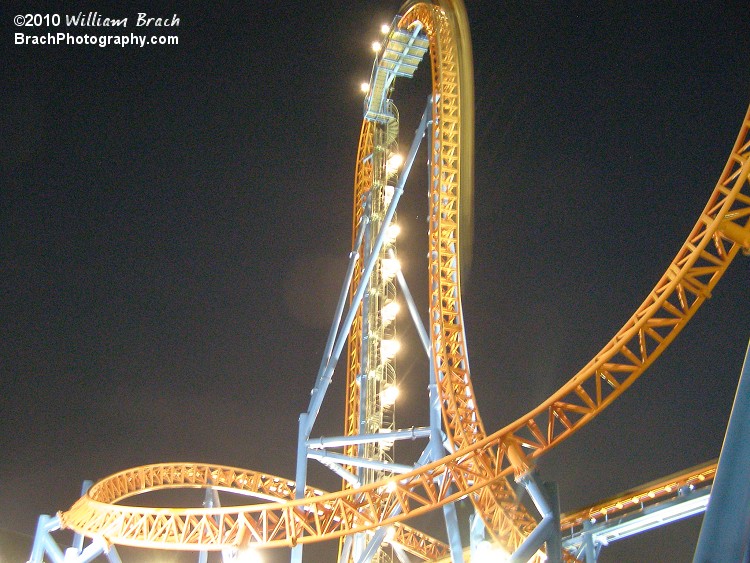 Lift hill, the 97-degree drop with a train going down the drop at night.