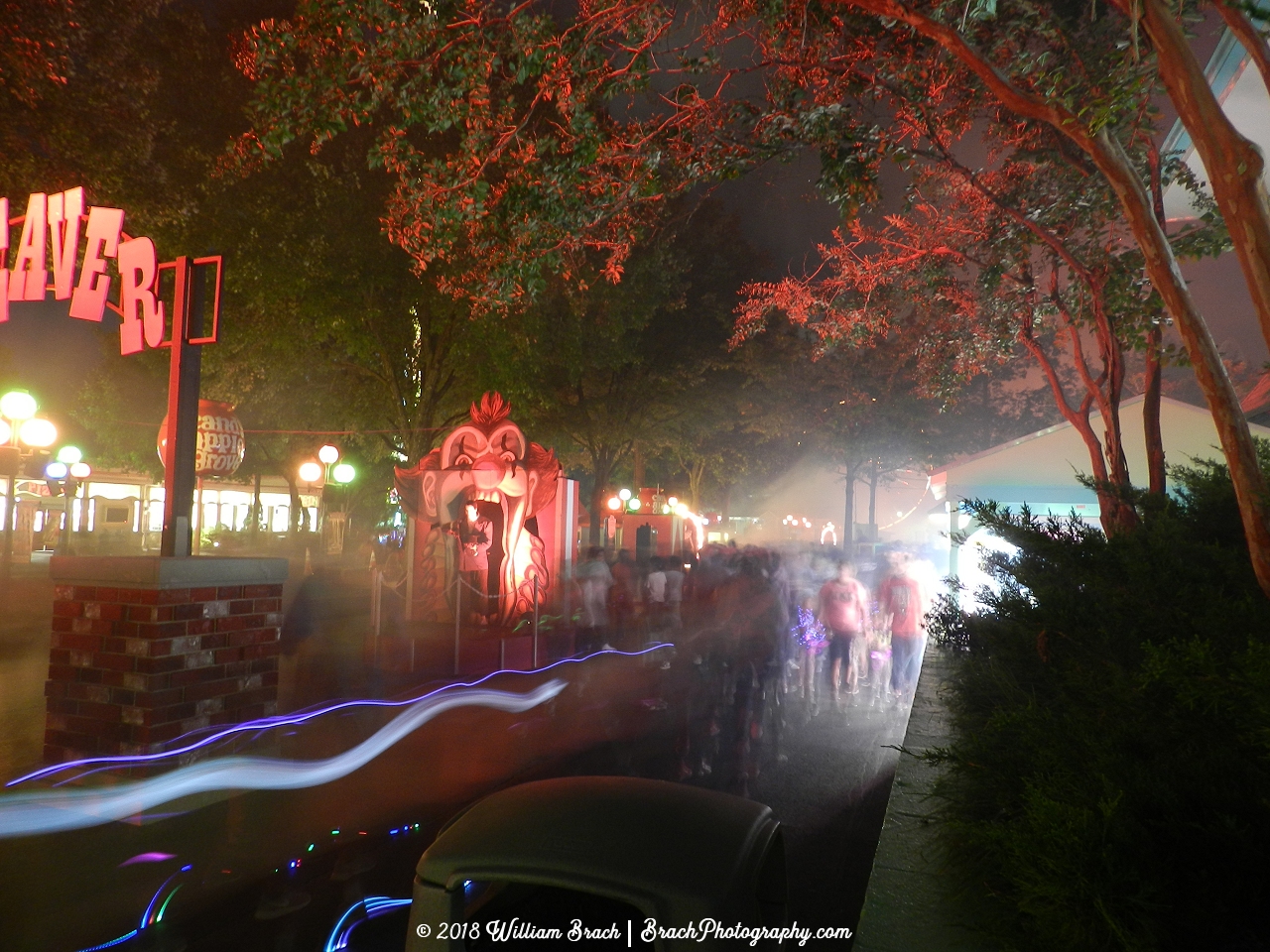 Entrance area to Cleaver Brothers Carnival all lit up at night.