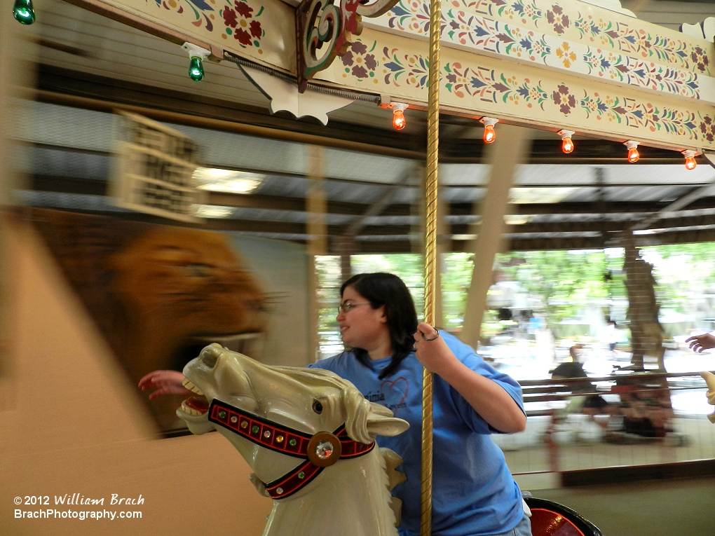 Staff Photographer Laura grabbing rings on the Grand Carousel.