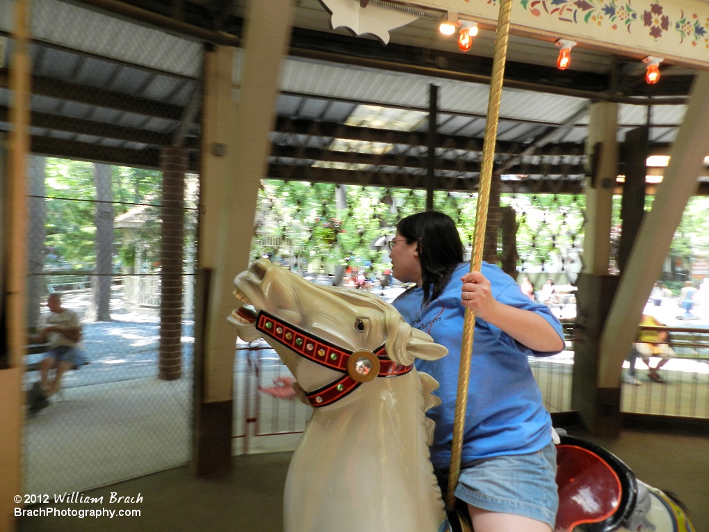 Staff Photographer Laura returning the rings she got while riding the Grand Carousel.