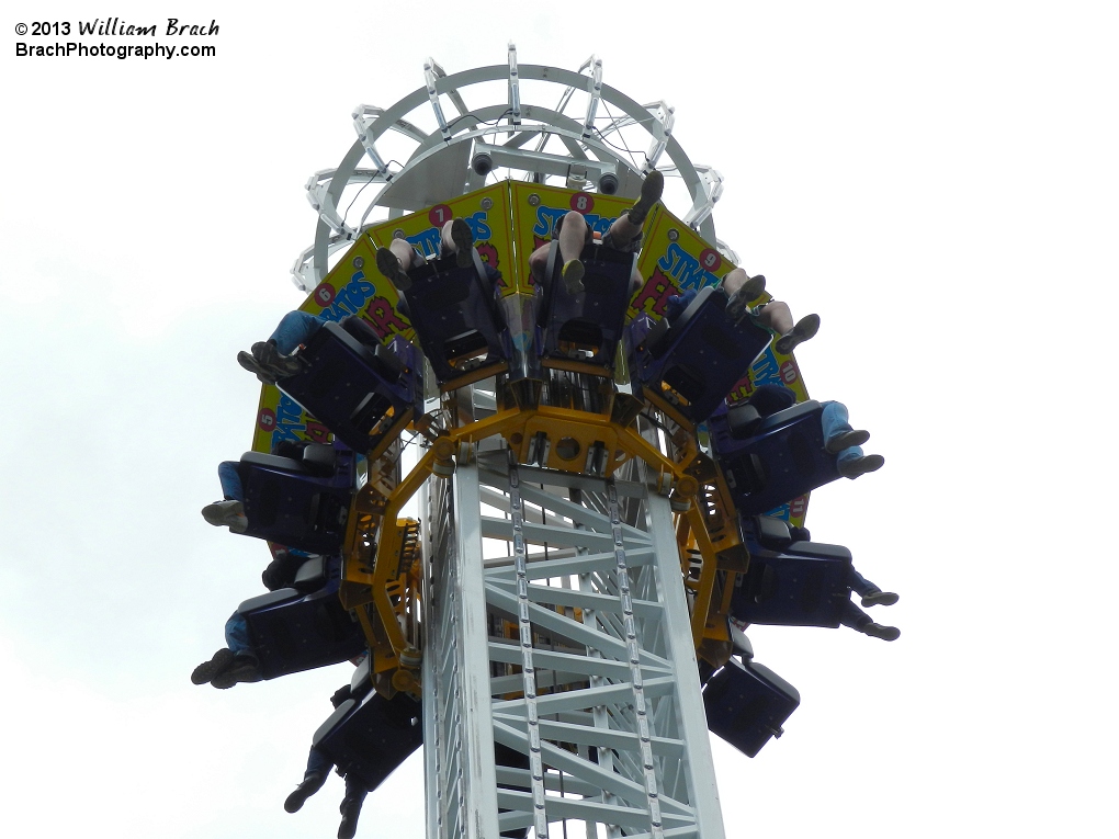 Riders at the top of the tower waiting to drop.