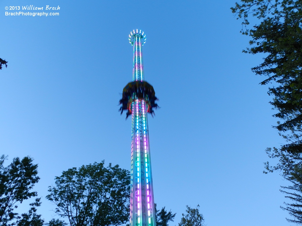 Riders going up StratosFear at dusk.