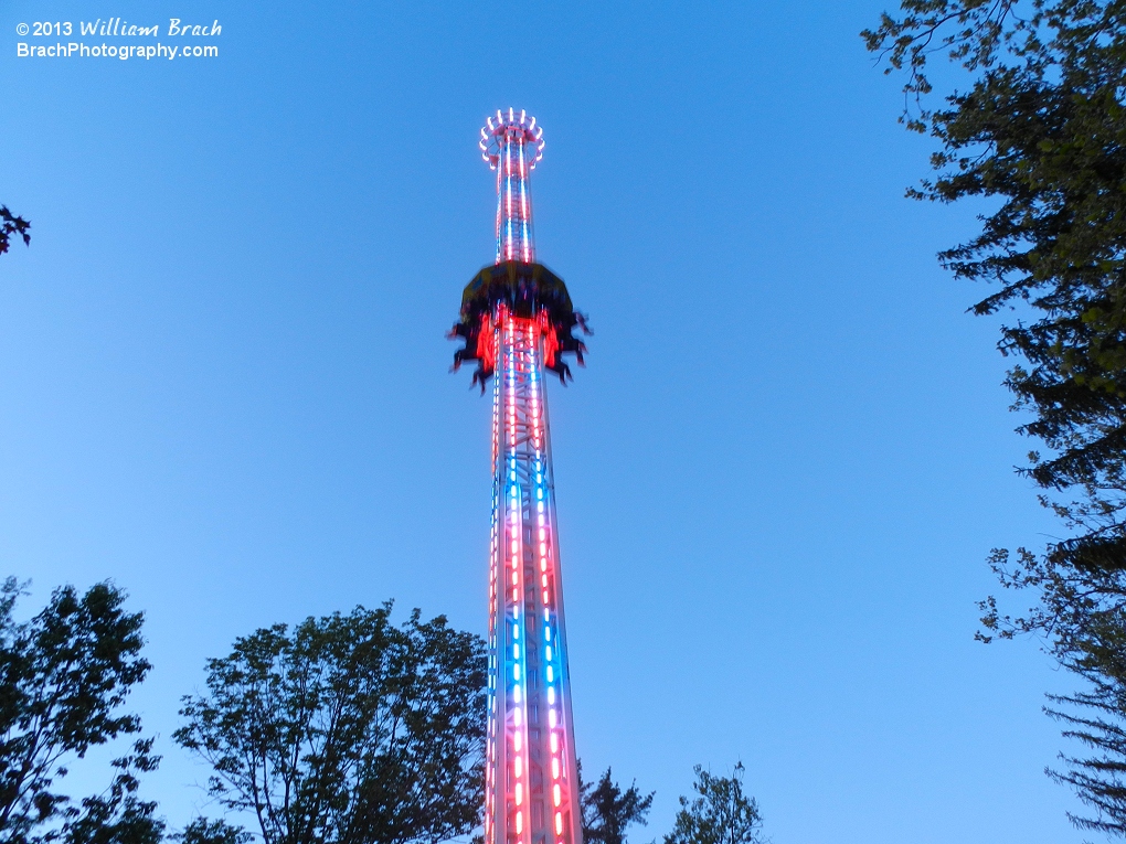 Riders going up StratosFear at dusk.