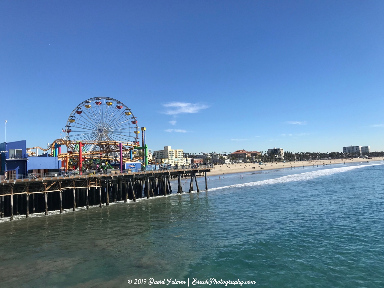 Looking at the beach and amusement park from the pier that extends out into the Pacific Ocean.