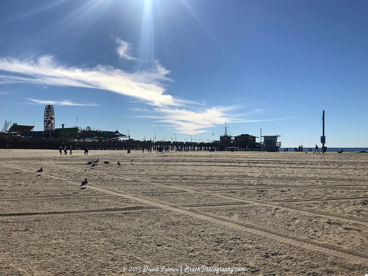 Views of piers and the park from the beach.