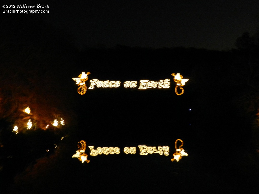 Zoomed in view of the sign on the railroad bridge.