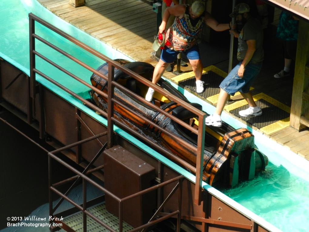 Passengers loading up into a log in Le Scoot's station.