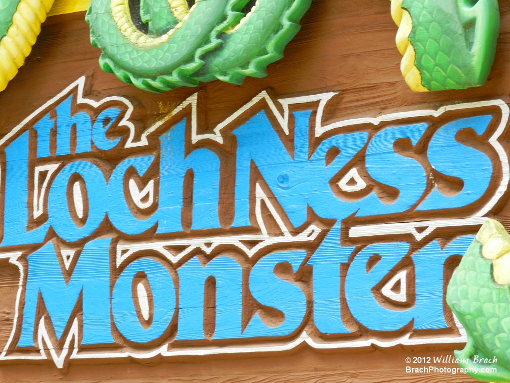 Closeup view of the sign on the Loch Ness Monster's queue line entrance.