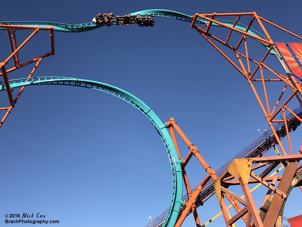 A full shot of the ride with the train in the barrel roll.