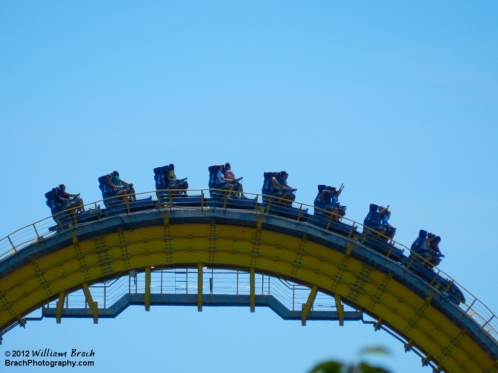 Here we see a train going over the top of the lift hill of Skyrush.