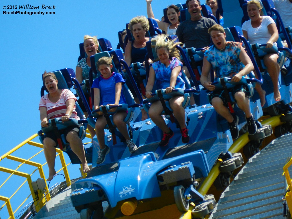 Closeup view of a train full of people about to go down the first drop.