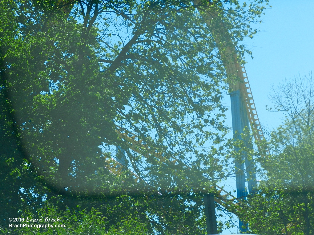 Looking at the first drop on Skyrush through the trees outside the park.