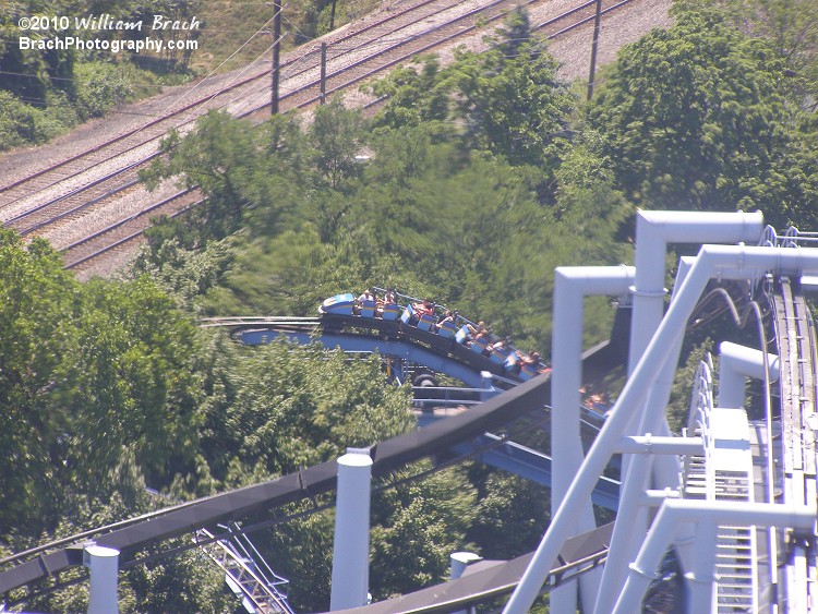 Designed by Anton Schwarzkopf.  Train is at the top fo the lift hill as seen here beyond Great Bear's lift hill from the Kissing Tower.