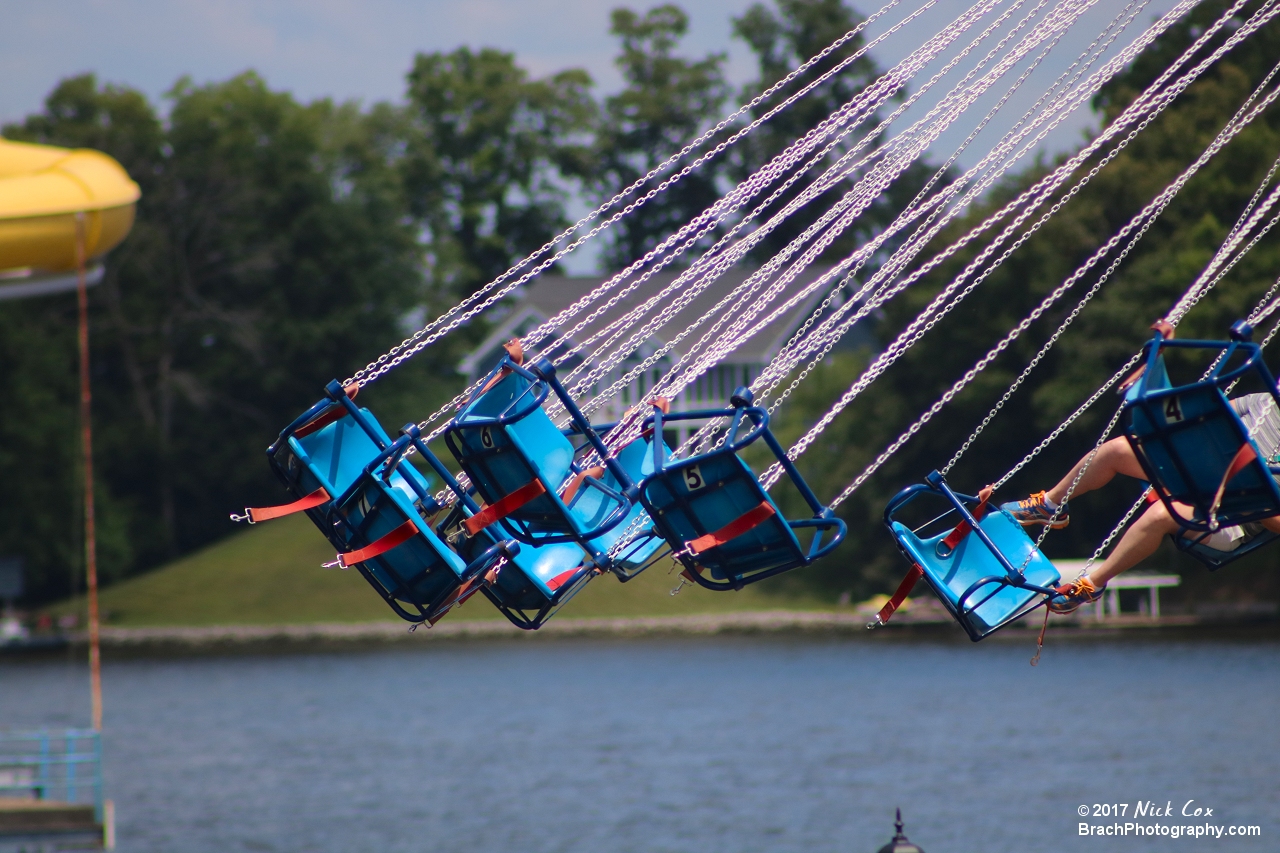 Swings flying over the water.