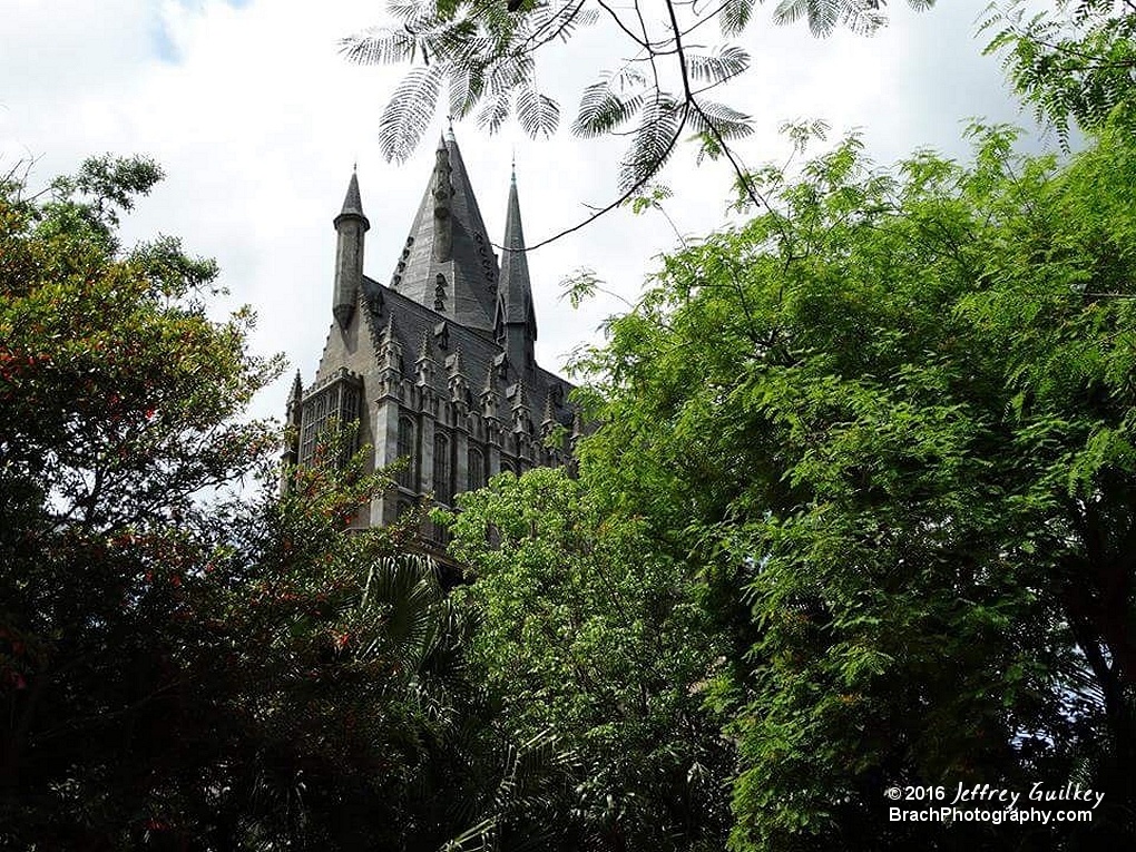 Hogwarts Castle peeking over the trees in IOA.