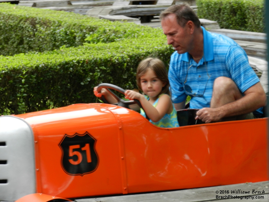 Kids take the opportunity to get behind the wheel and drive mom or dad around the track of the ride.