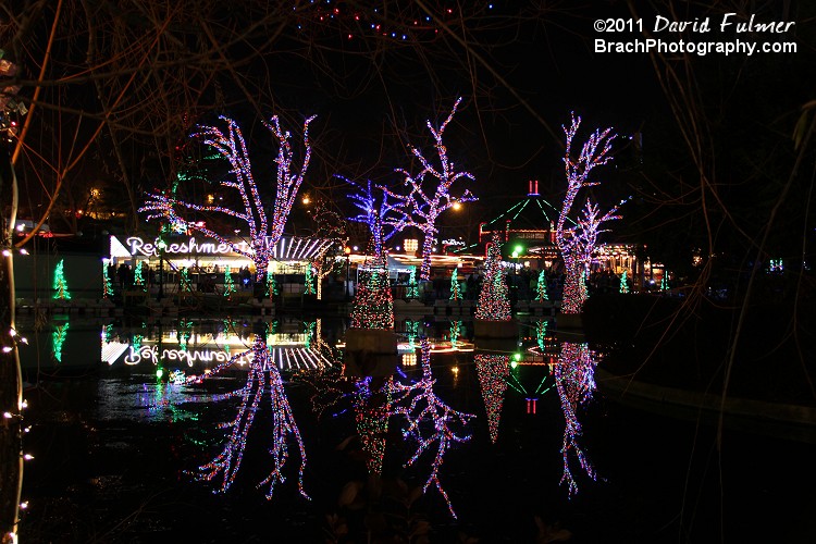 Holiday lights reflection in water lagoon.