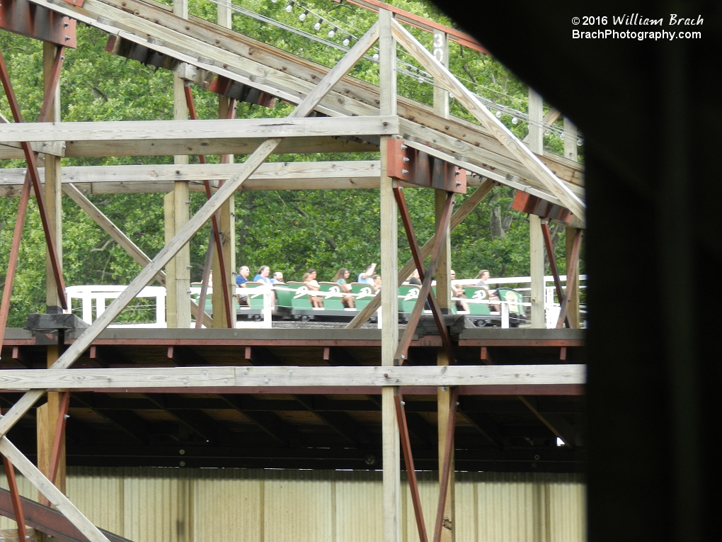 Looking at the green train of Jack Rabbit through the supports of Racer.