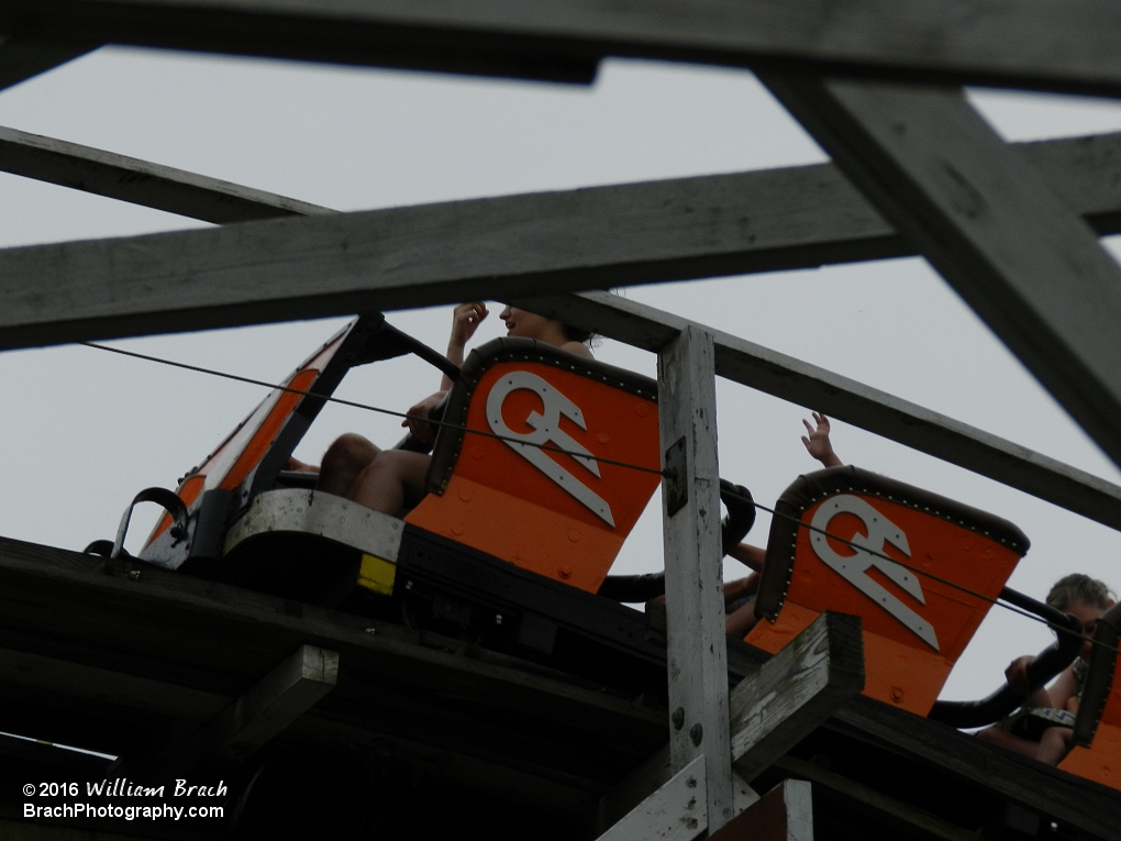 Orange train going up the lift hill.