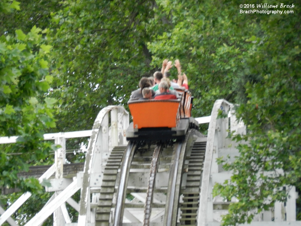 Orange train entering the turn ebfore the lift hill.