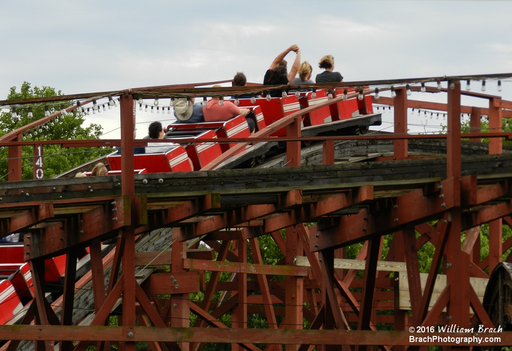 Racer's red train going up a hill.