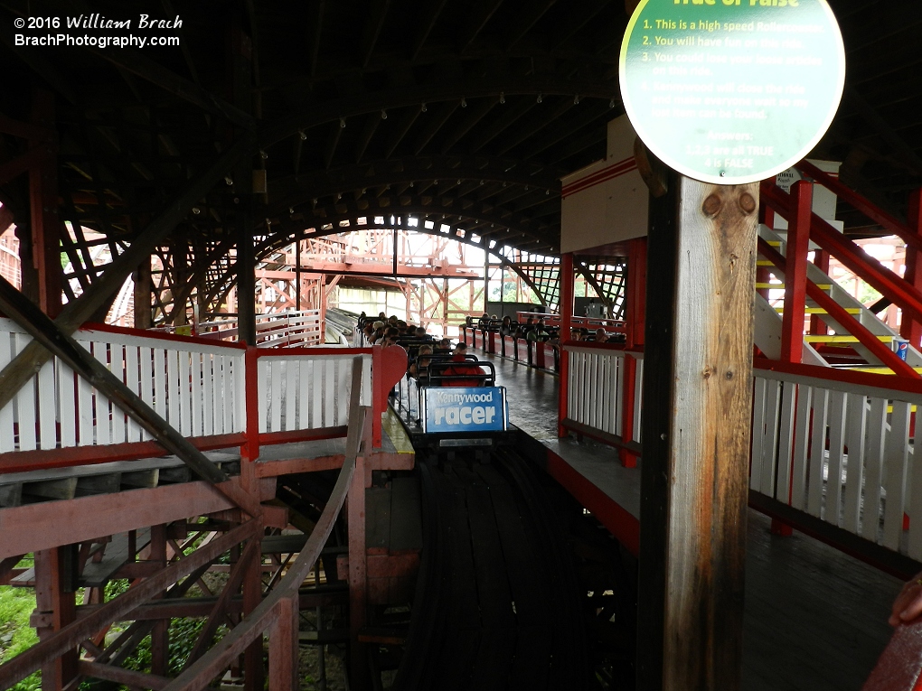 Racer's blue train sits on the left side of the station, but will return to the right side.  This coaster is one of the few continuous track coasters in the world.