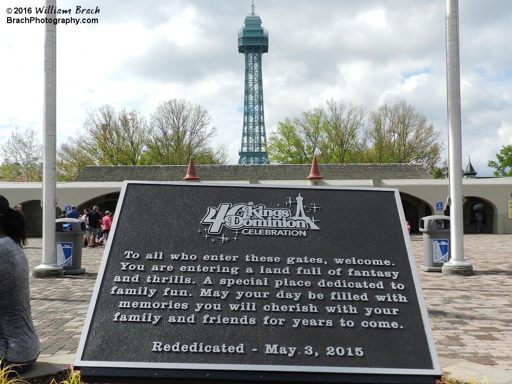 The plaque is not level with the entrance gates and the Eiffel Tower.