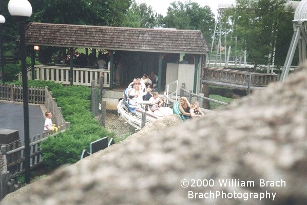 Avalanche train departing the station as seen from the queue line of Volcano.