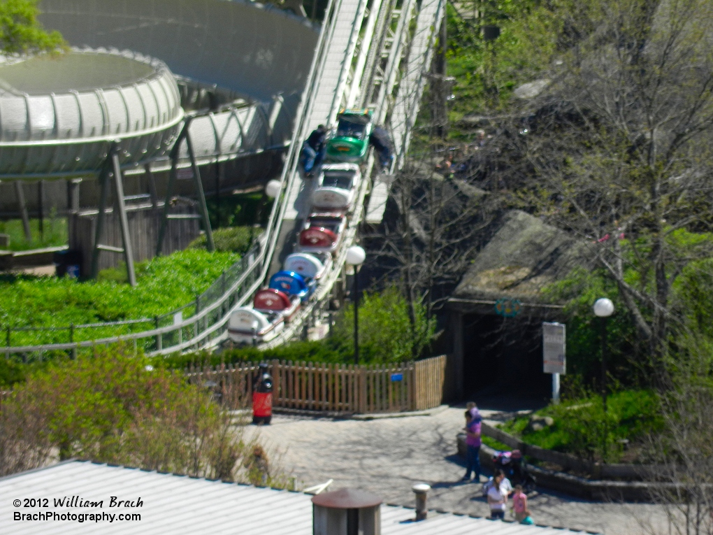 Here we see two mechanics working on the lead car of the Avalanche train on the lift hill.