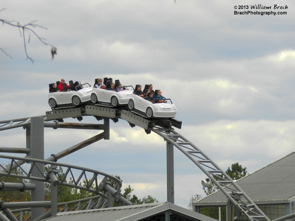 Backlot Stunt Coaster's white train leaving the Parking Garage.