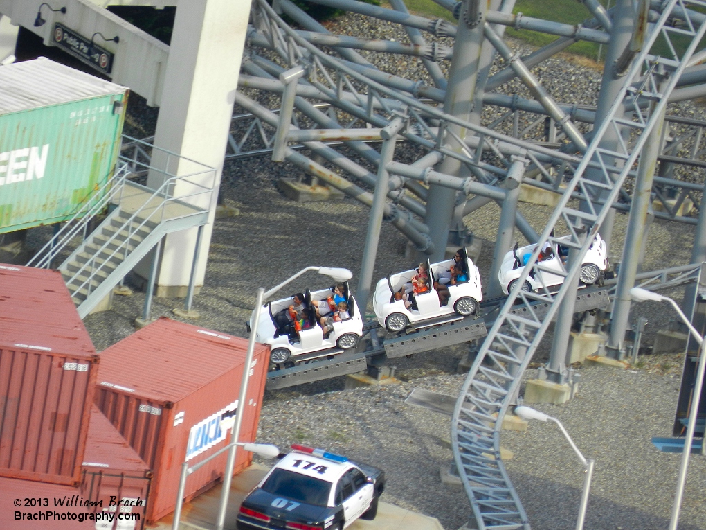 Backlot Stunt Coaster's white train leaving the stairwell and headed towards the fire scene.