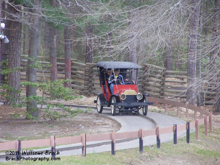 Red car making its way back to the station.