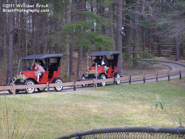 Two red cars slowing down prior to the station.