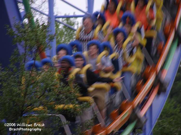 Coaster Crew members wearing their black and white striped shirts seen riding Shockwave.