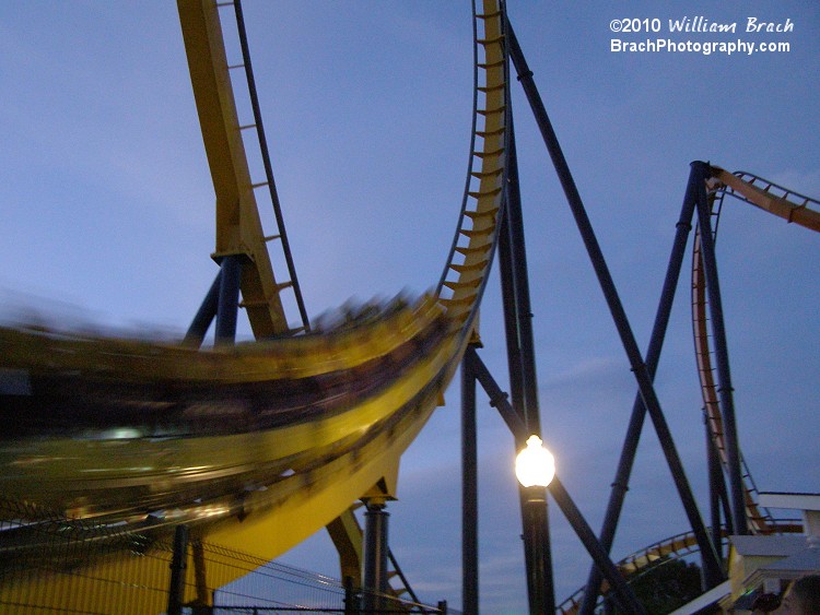 Dominator train entering the vertical loop at night.