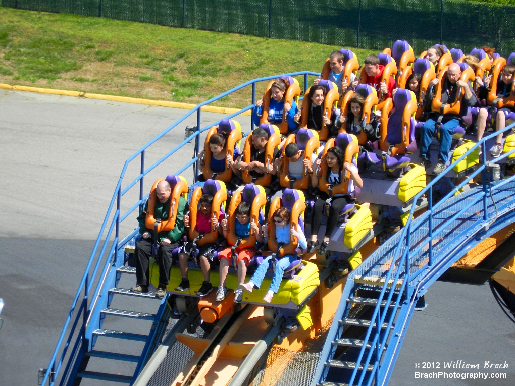 Floorless coaster train cresting the top of the lift hill.