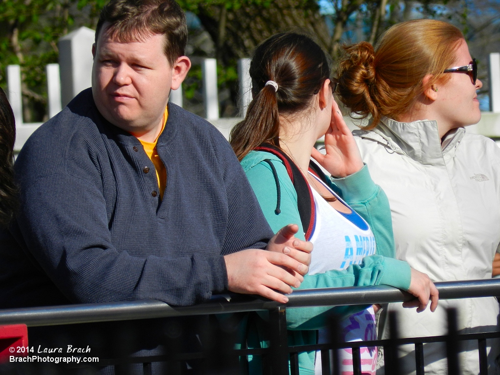 Being a deaf guy standing in the queue, I can't hear anything.  I leave my hearing aids off on anything that has OTSRs.  (Over The Shoulder Restraints)