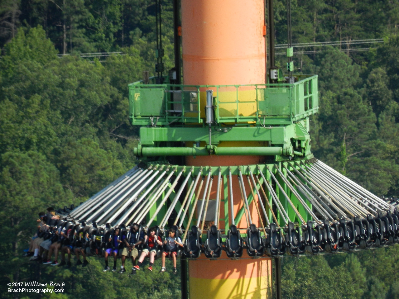 Drop Tower riders going up to the top of the tower.